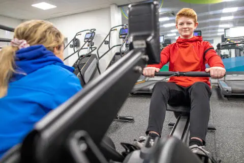 Young person and a Bury Leisure instructor in a gym