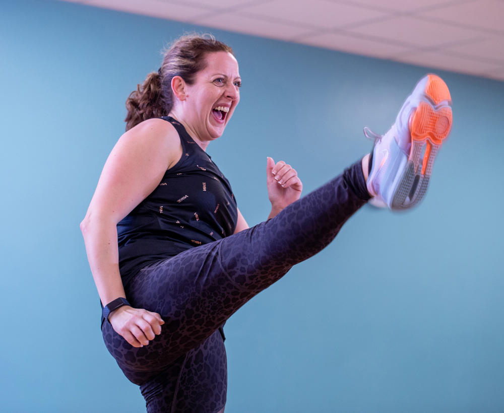 Woman taking part in a fitness class at Castle Leisure Centre