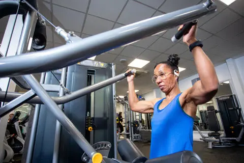 Woman with lateral pull down