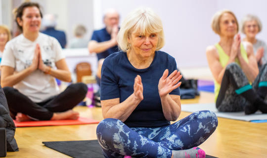 Women taking part in a yoga class at Castle Leisure Centre