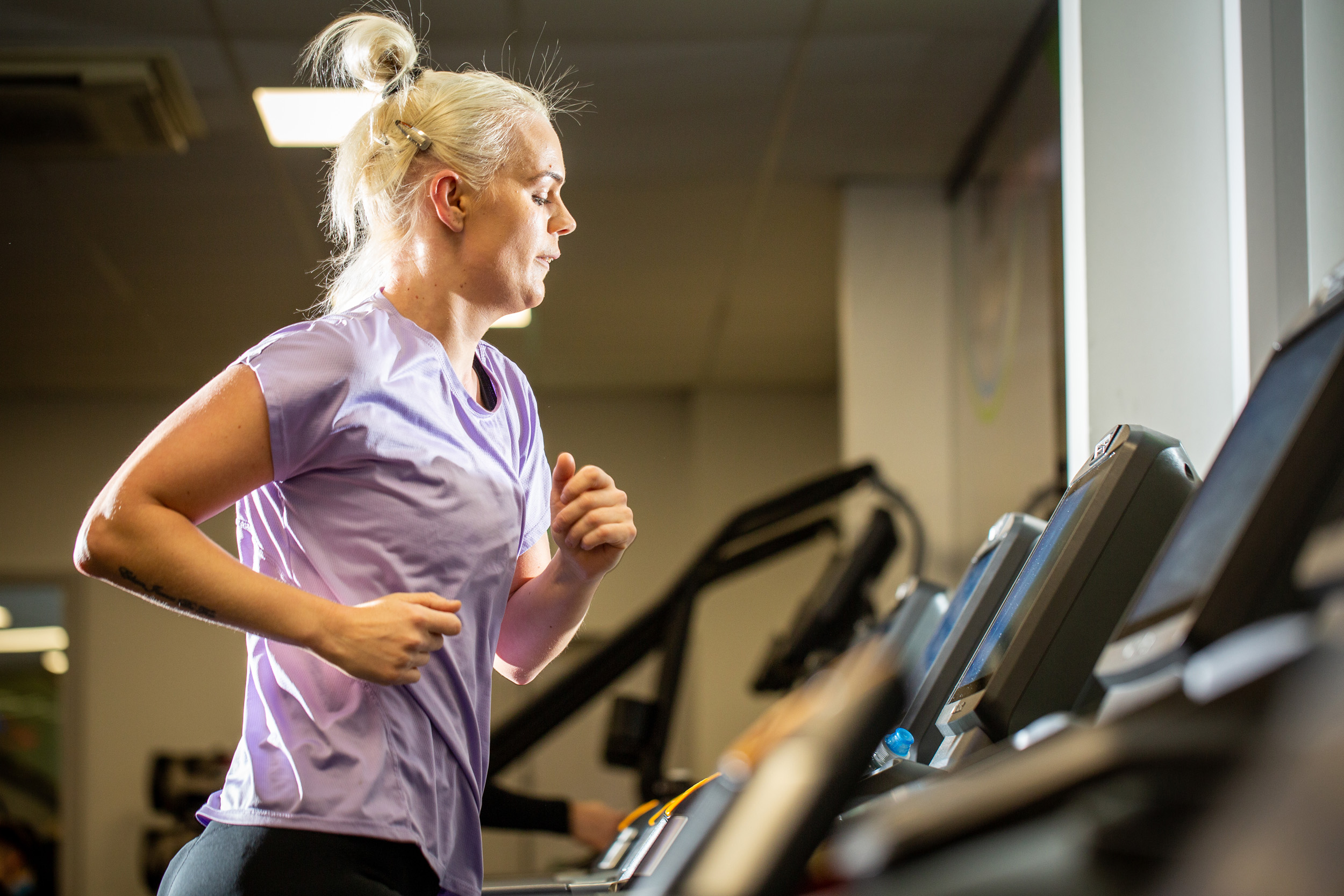Woman using running machine
