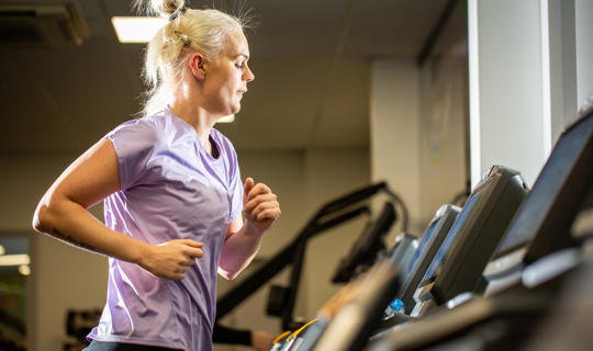 Woman using running machine