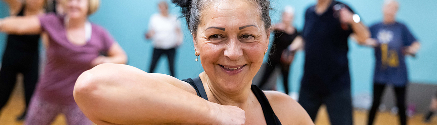 Men and women taking part in a fitness class at Castle Leisure Centre