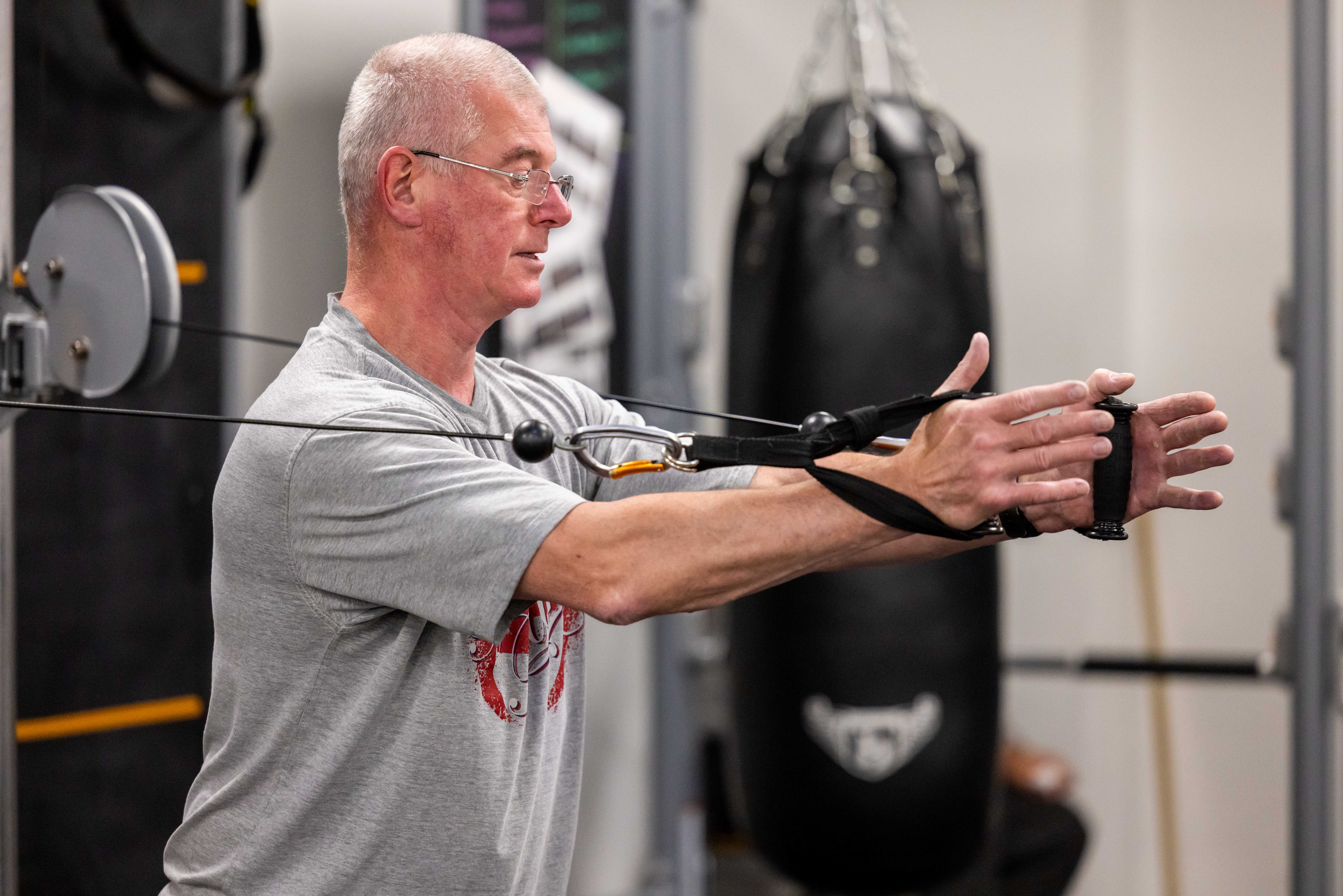 Man using strength equipment in the gym at Castle Leisure Centre