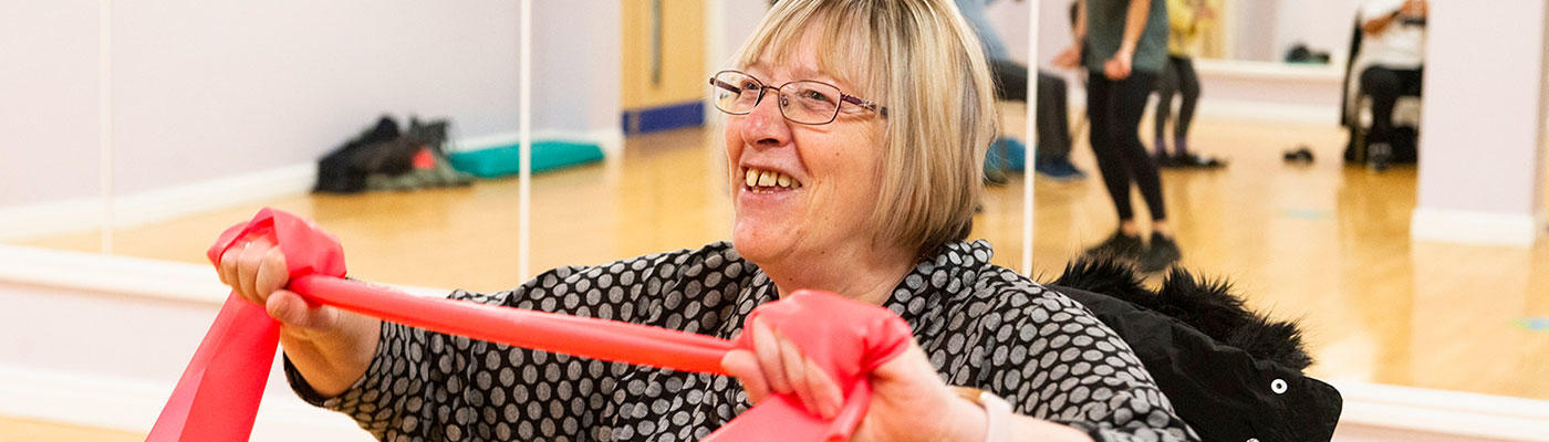 Smiling customer taking part in a gentle exercise class