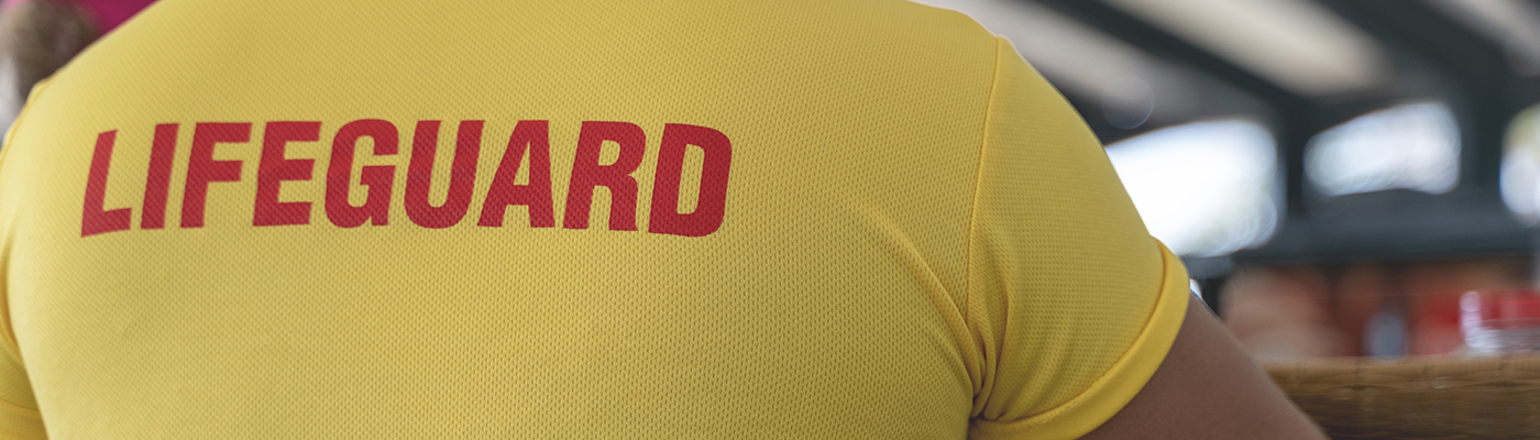 Man wearing a yellow t-shirt with the word lifeguard written on it