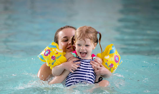 Girl enjoying a parent and child swim session