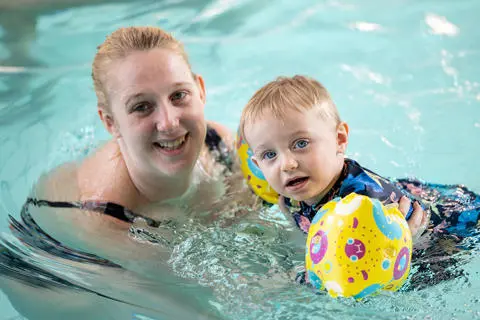 Adult and child in swimming pool