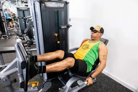 A man using strength equipment in a gym