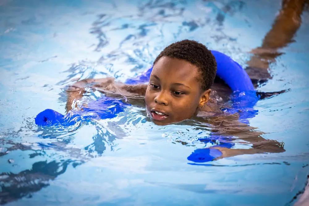 Boy taking part in a swimming class at Radcliffe Leisure Centre pool
