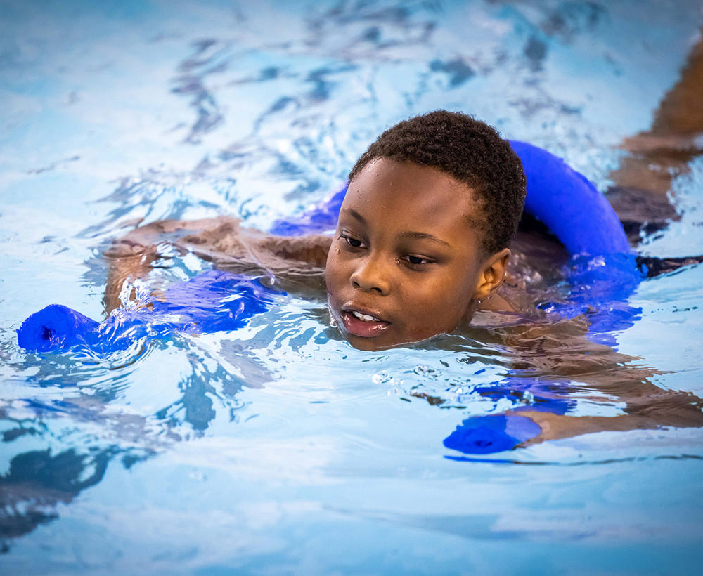 Boy taking part in a swimming class at Radcliffe Leisure Centre pool