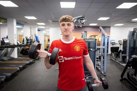 Man using hand weights in a gym