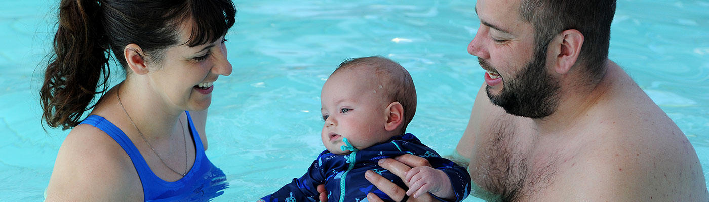 Parents and child in a swimming pool