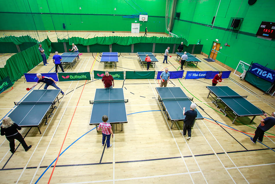 Table tennis tables and participants in the sports hall