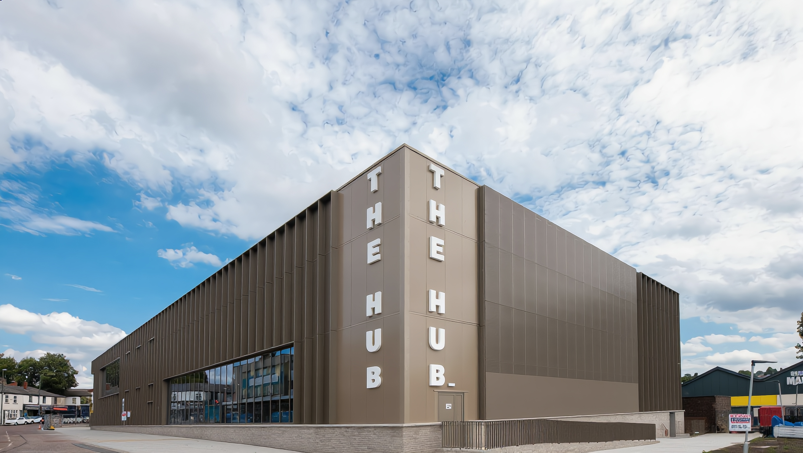 External view of a large, cladded building that will provide a leisure centre, library and wellbeing support.